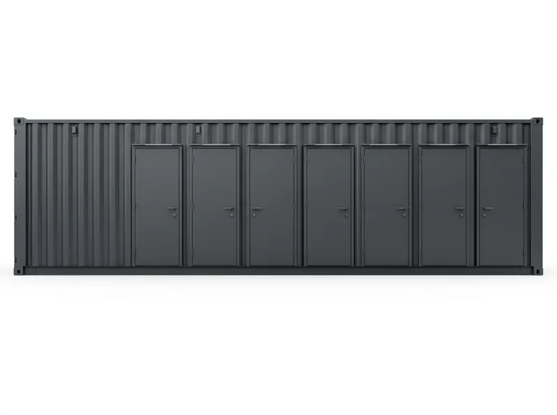 A dark grey container washroom block with seven doors along its length.